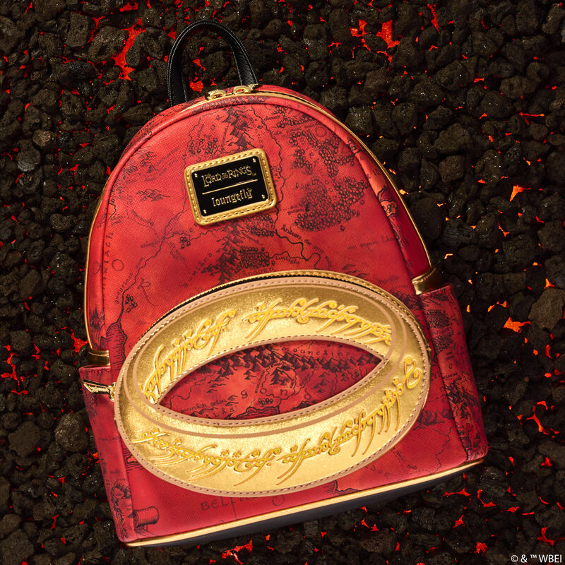Loungefly Lord of the Rings mini backpack that is red with an all-over print of a map of Middle Earth. The front pocket features a gold appliqué of the One Ring, featuring an elvish script of Black Speech that glows in the dark. The bag sits against a background of glowing coals. 